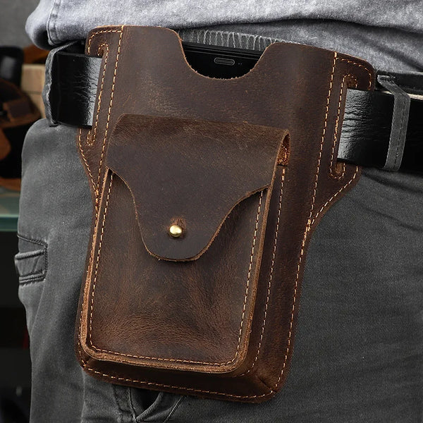 Brown leather pouch on a person's waist with a blurred background