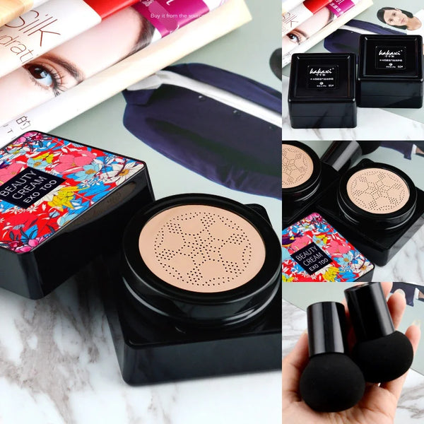 Makeup compact with colorful packaging, two black compacts, and makeup brushes on a marble surface.